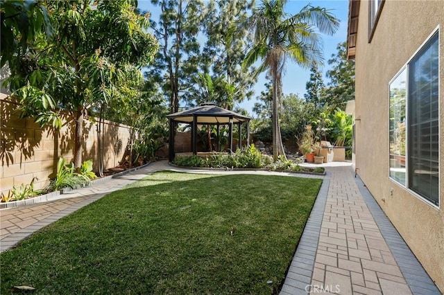 view of yard with fence and a gazebo