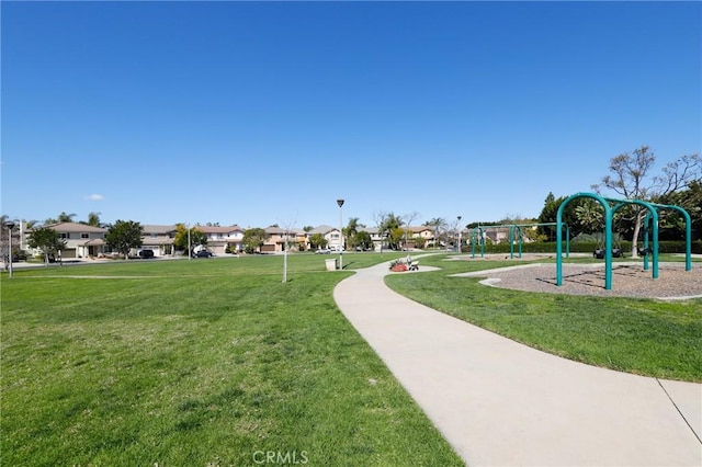 view of property's community featuring a residential view, playground community, and a yard