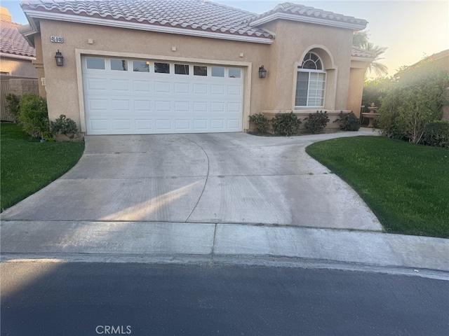 mediterranean / spanish-style home featuring concrete driveway, a tile roof, and stucco siding