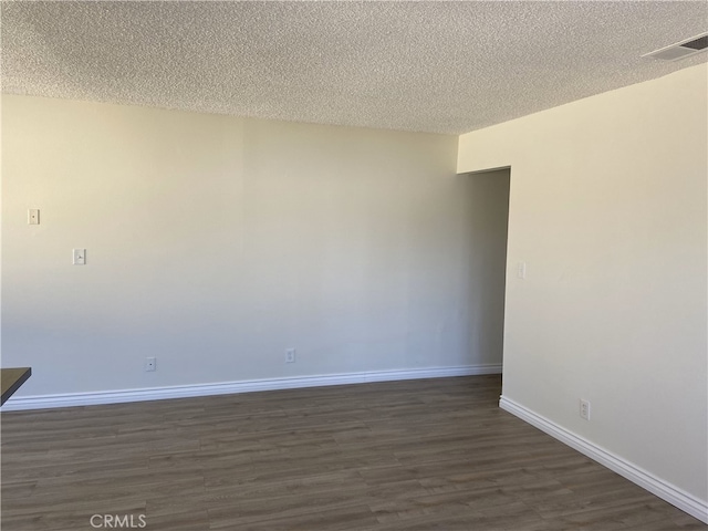 18209 Camino Bello Unit 4, Rowland Heights, CA 91748 - unfurnished room with baseboards, visible vents, a textured ceiling, and dark wood-style flooring
