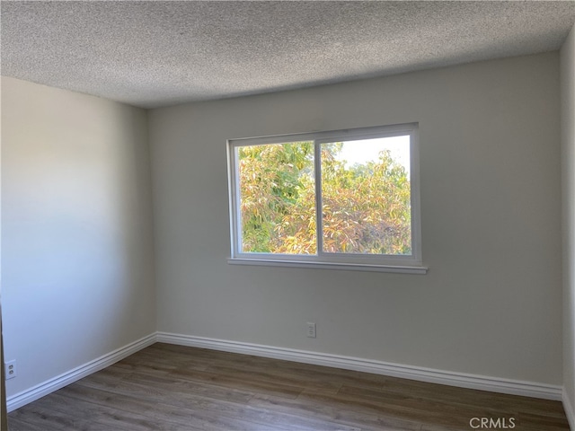 18209 Camino Bello Unit 4, Rowland Heights, CA 91748 - spare room with a textured ceiling, dark wood-style floors, and baseboards
