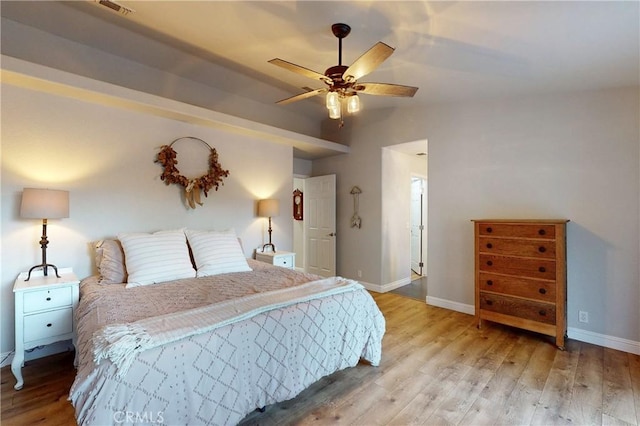 bedroom with light wood-style floors, visible vents, and baseboards