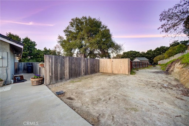 view of yard featuring fence and a patio