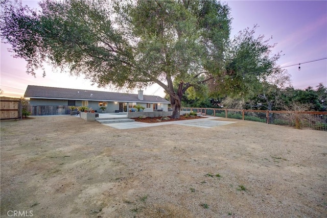 view of yard with driveway and a fenced backyard