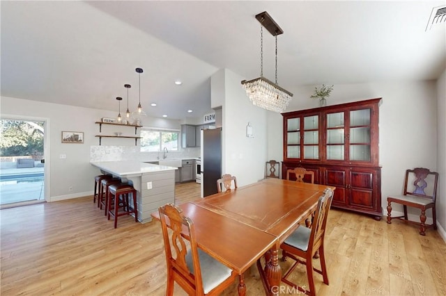 dining room with light wood-style floors, recessed lighting, visible vents, and baseboards