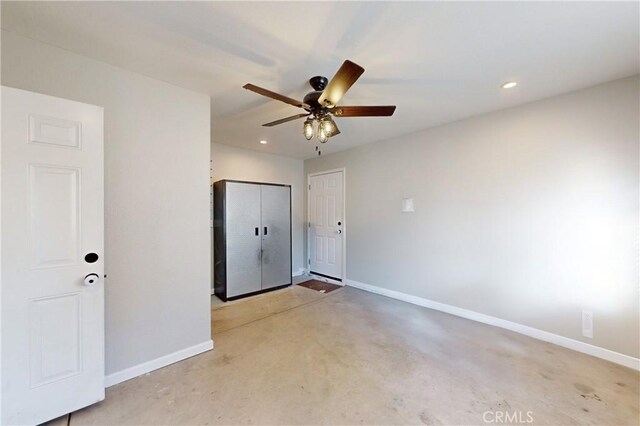 empty room with concrete floors, baseboards, and recessed lighting