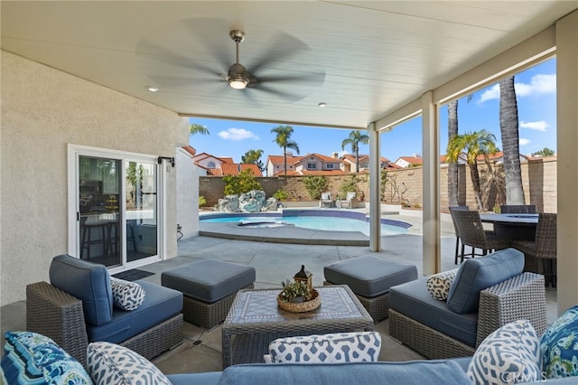 view of patio / terrace with a fenced in pool, outdoor lounge area, a fenced backyard, and a ceiling fan