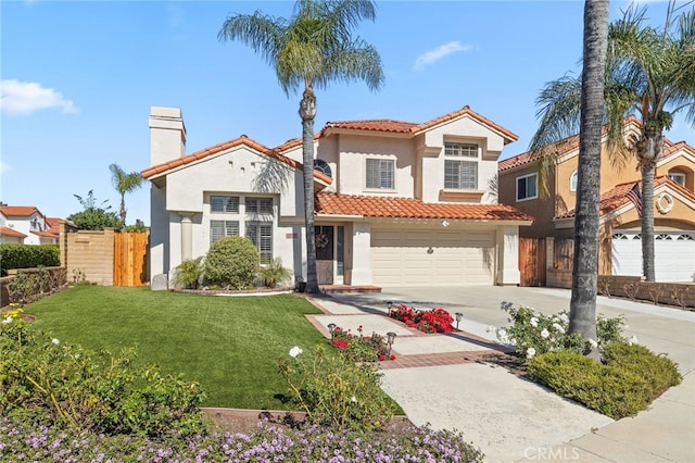 mediterranean / spanish-style home with a front yard, fence, stucco siding, concrete driveway, and a tile roof