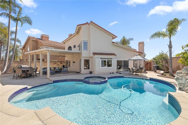 view of swimming pool with an outdoor hangout area, a patio, a fenced backyard, outdoor dining space, and a ceiling fan