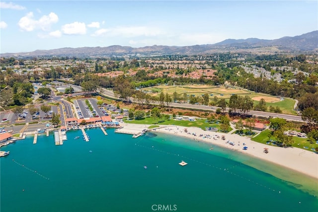 birds eye view of property with a water and mountain view