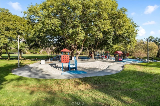 communal playground featuring a yard