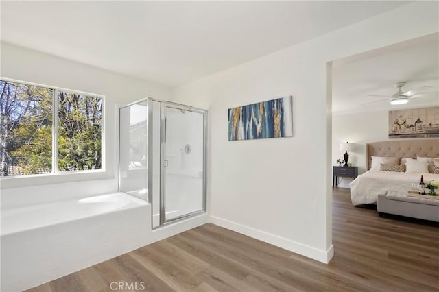 bedroom featuring baseboards and wood finished floors