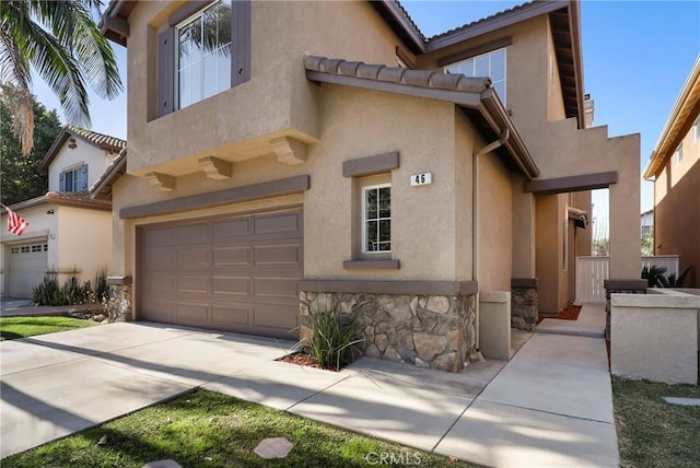 view of front of property with a garage, stone siding, driveway, and stucco siding