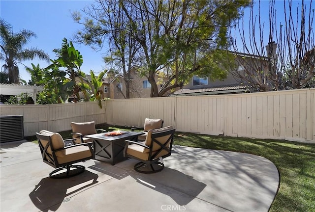 view of patio / terrace featuring an outdoor fire pit and a fenced backyard