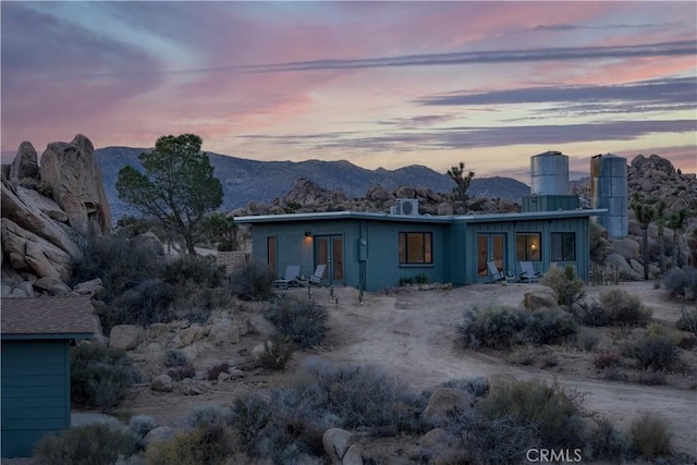 back of house with a mountain view