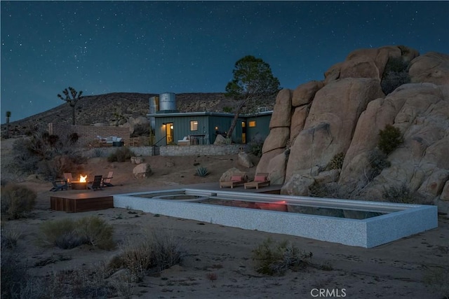 exterior space featuring an outdoor fire pit