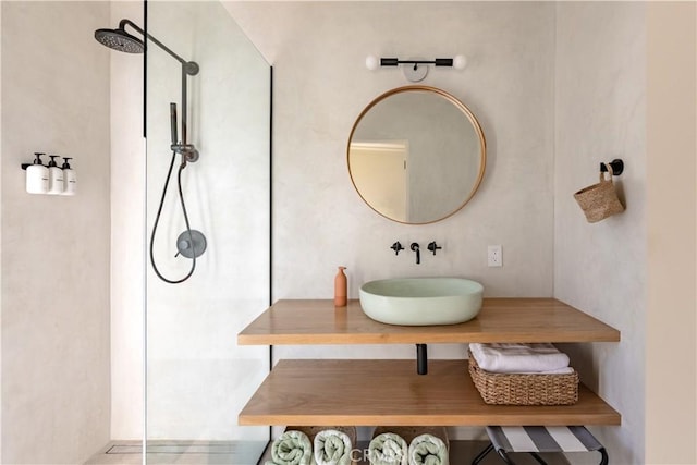 bathroom with a shower and vanity