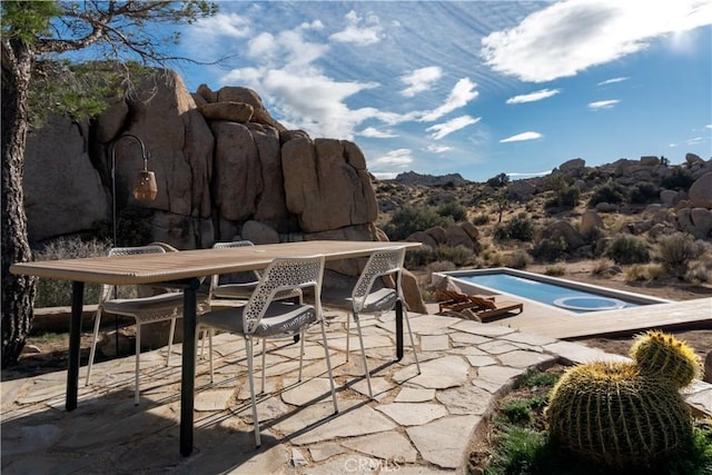 pool featuring a patio area and outdoor dining area