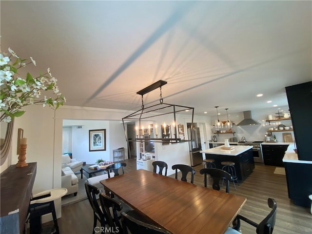 dining area with recessed lighting and wood finished floors