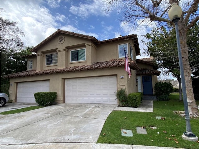 view of front of property with a tiled roof, a garage, driveway, and stucco siding