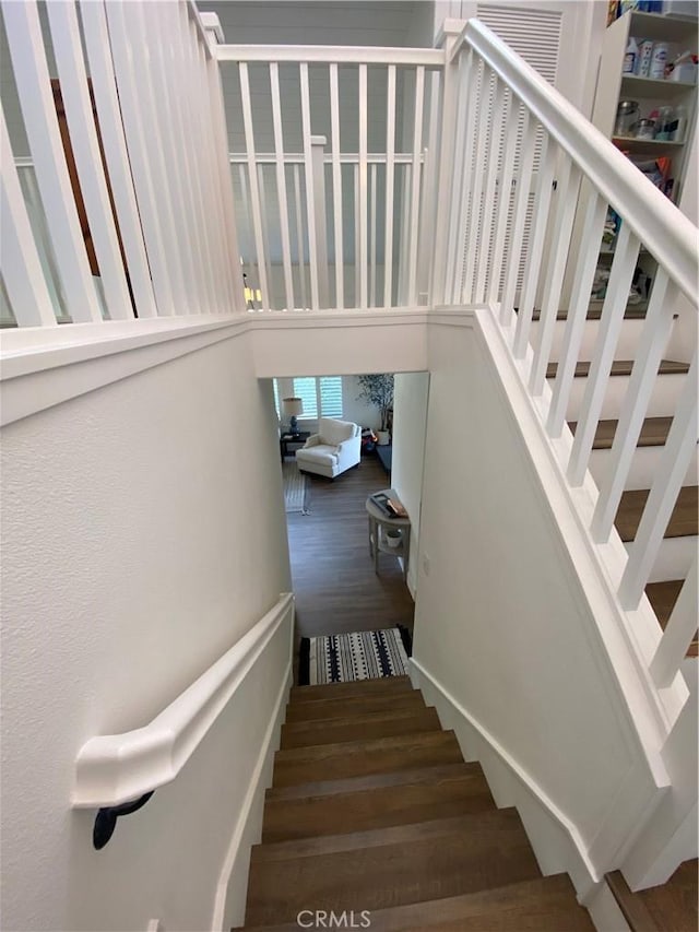 stairway featuring wood finished floors