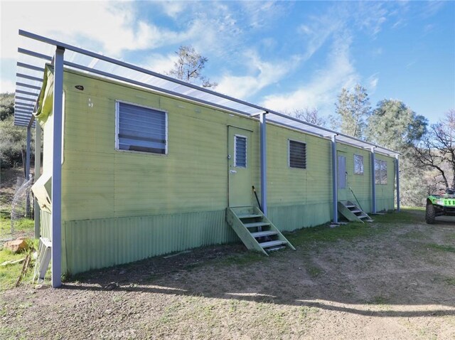 rear view of property featuring entry steps