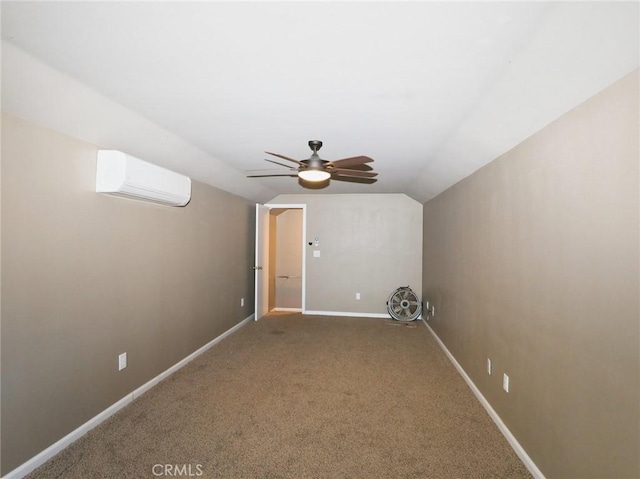 interior space with baseboards, carpet, a wall mounted air conditioner, lofted ceiling, and a ceiling fan