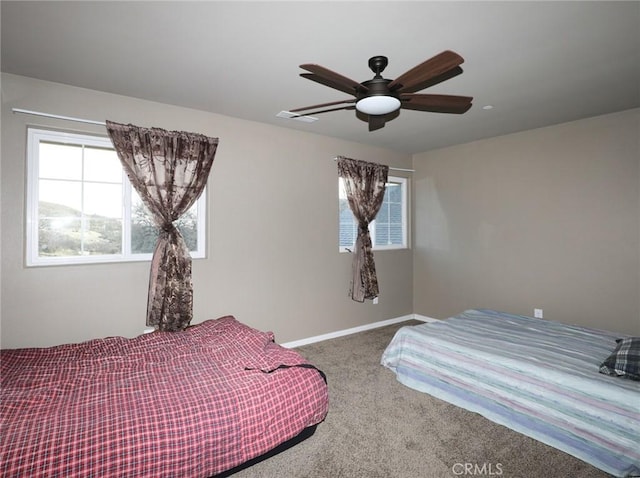 bedroom with visible vents, baseboards, ceiling fan, and carpet flooring