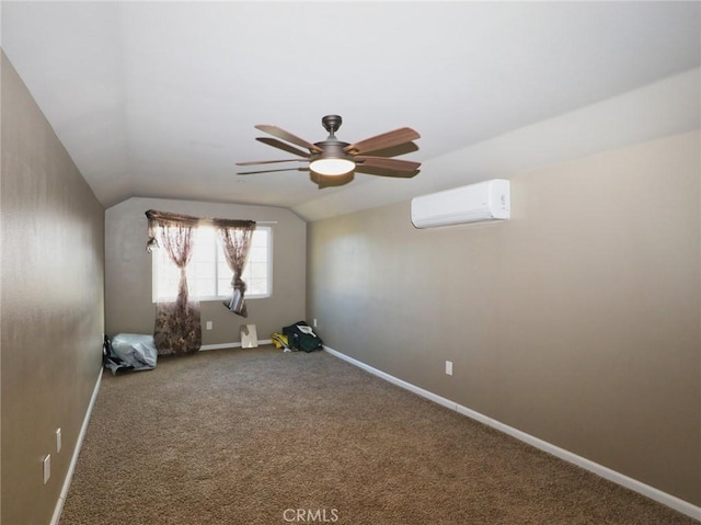 empty room with a wall mounted air conditioner, carpet flooring, baseboards, ceiling fan, and vaulted ceiling