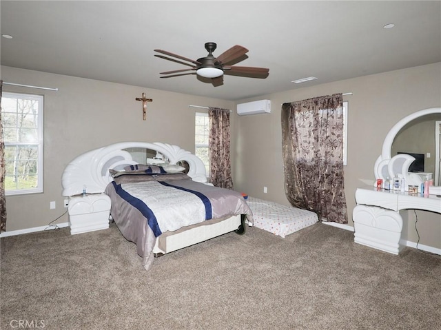 carpeted bedroom featuring visible vents, baseboards, an AC wall unit, and a ceiling fan