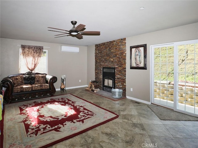 living area with baseboards, an AC wall unit, ceiling fan, and a fireplace