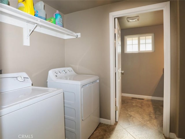 laundry area featuring laundry area, independent washer and dryer, and baseboards