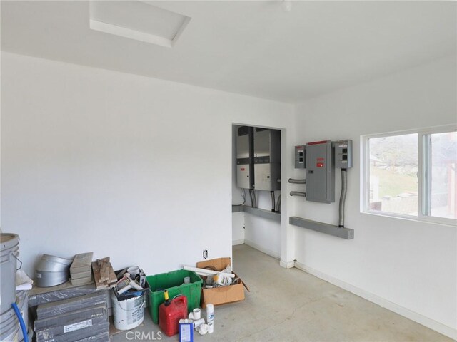 interior space featuring electric panel and baseboards