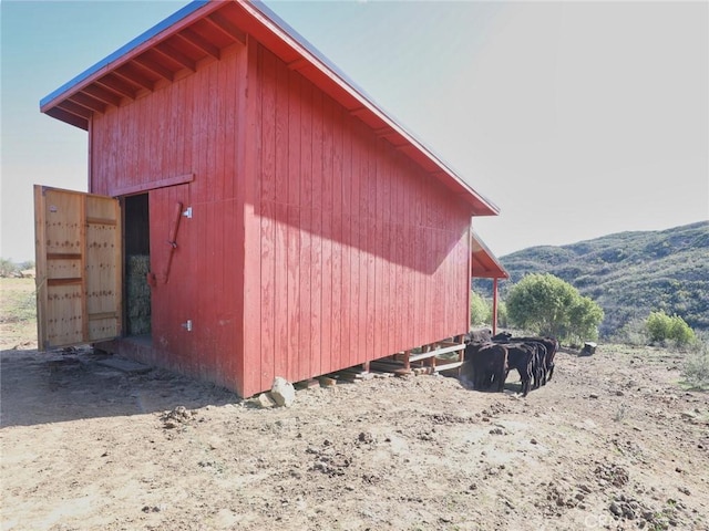 view of outbuilding featuring a mountain view and an outdoor structure