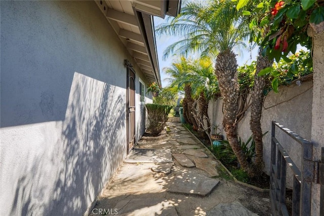 view of property exterior featuring a patio area, a fenced backyard, and stucco siding