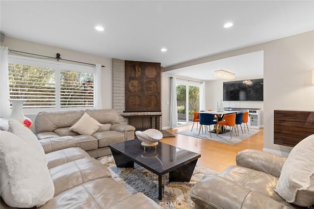 living room featuring baseboards, wood finished floors, and recessed lighting