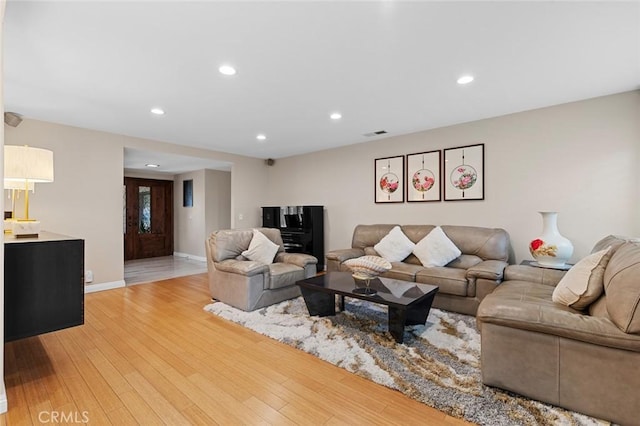 living area featuring baseboards, recessed lighting, visible vents, and light wood-style floors