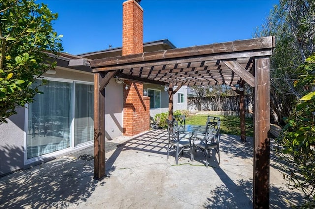 view of patio with outdoor dining area, fence, and a pergola