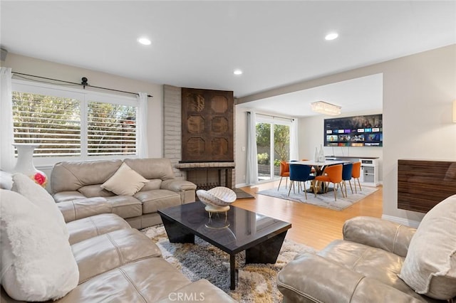 living room with recessed lighting, baseboards, and wood finished floors