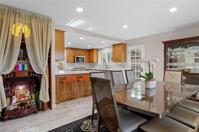 dining space with marble finish floor and recessed lighting