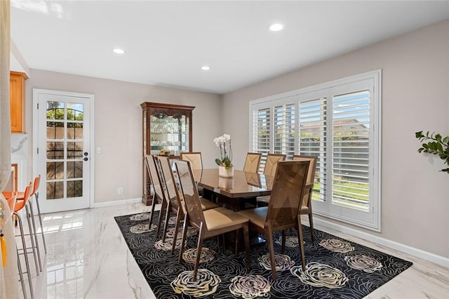 dining area with recessed lighting, marble finish floor, plenty of natural light, and baseboards