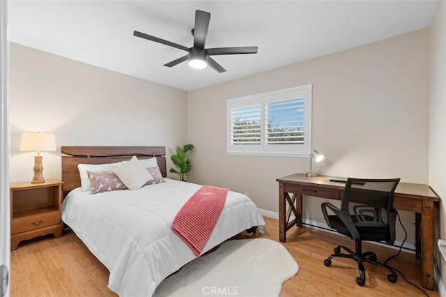 bedroom with light wood finished floors, ceiling fan, and baseboards