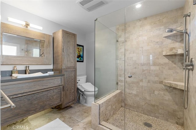 full bathroom featuring visible vents, vanity, a shower stall, and toilet