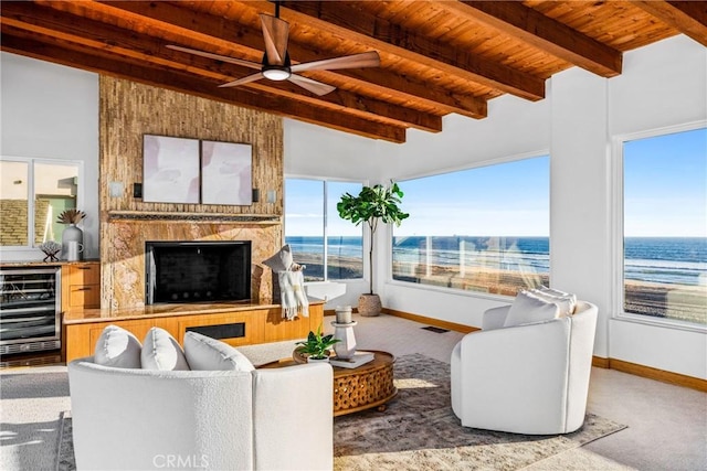 living room with wood ceiling, beverage cooler, carpet flooring, and a premium fireplace