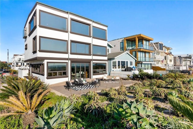 back of property featuring a patio area and stucco siding