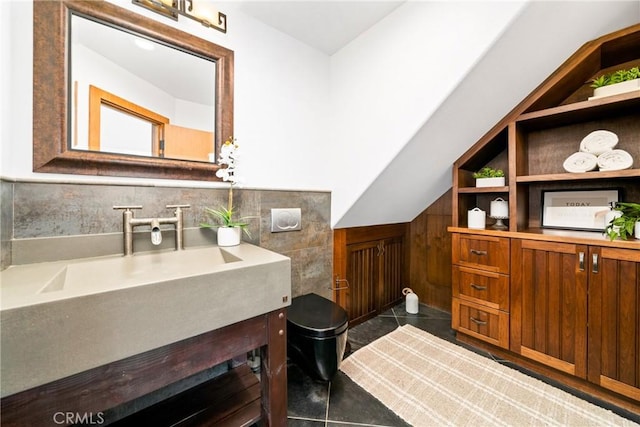 bathroom with lofted ceiling and vanity