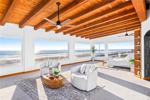 sunroom / solarium with wood ceiling, ceiling fan, and lofted ceiling with beams