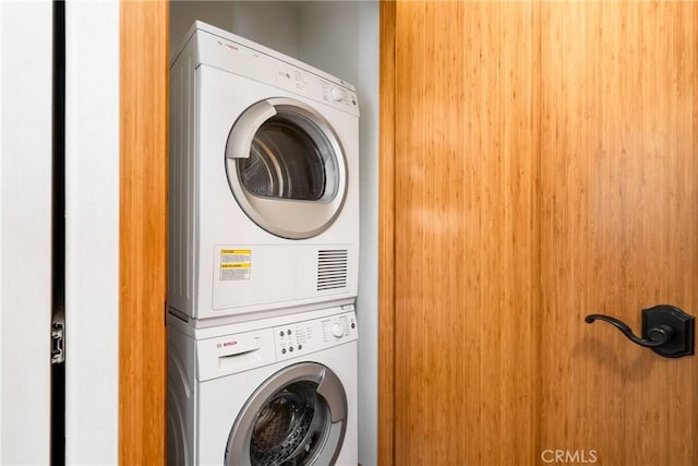 laundry area featuring laundry area and stacked washer / dryer