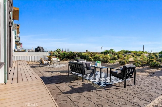 view of patio with a wooden deck and an outdoor living space