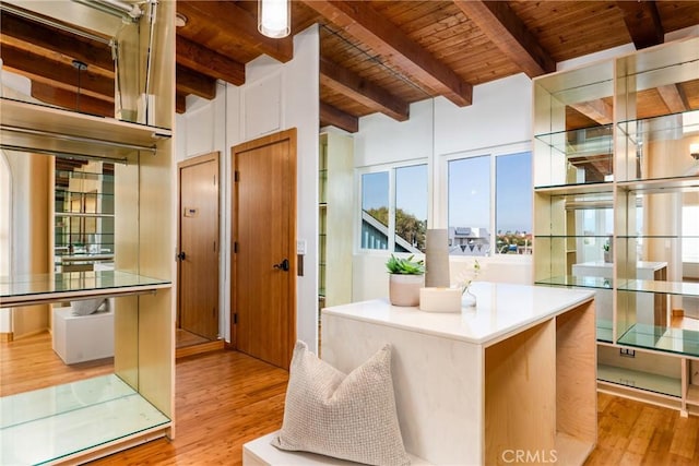 kitchen featuring wooden ceiling, wood finished floors, and beamed ceiling